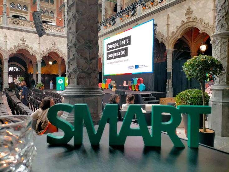 The word SMART with the meeting venue in the background