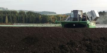 Machines turning over agricultural compost piles 