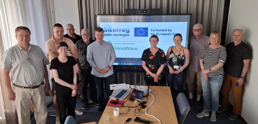 Planning event of group procurements at Lappeenranta region A group of eleven people standing at the front of screen and behind the table