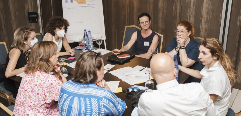 People around a table and working together People around a table and working together