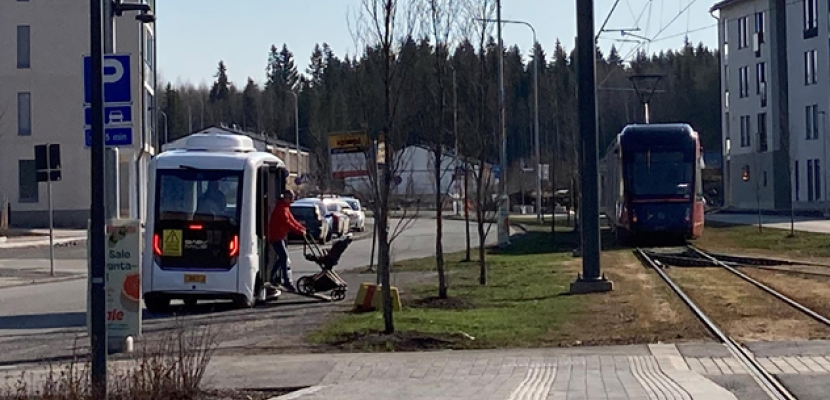 Passenger is getting off from an autonomous shuttle bus at the Hervantajärvi tram stop