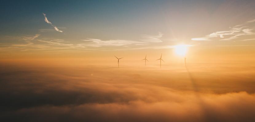 A group of windmills in the sky above the clouds A group of windmills in the sky above the clouds