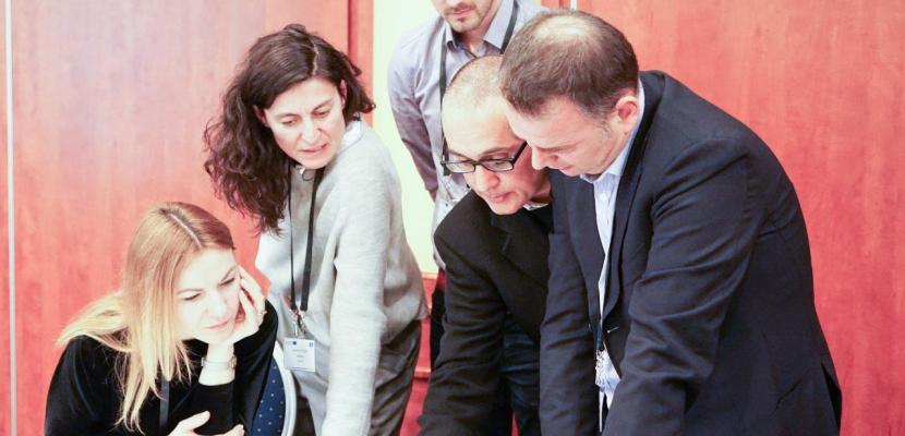 People looking at papers on a table