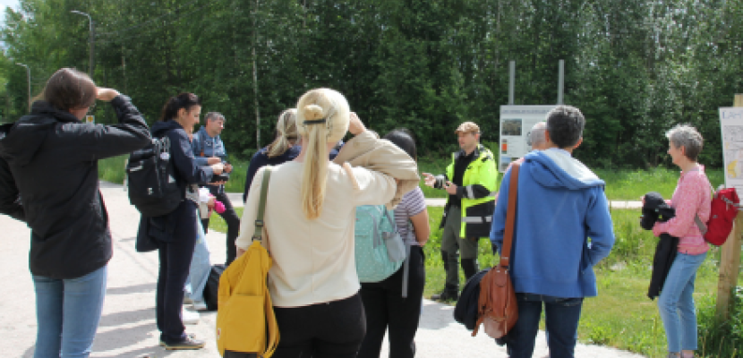ClimateGO project partners participated in the Climate-change walk People standing outside, listening to an expert's presentation about the destination