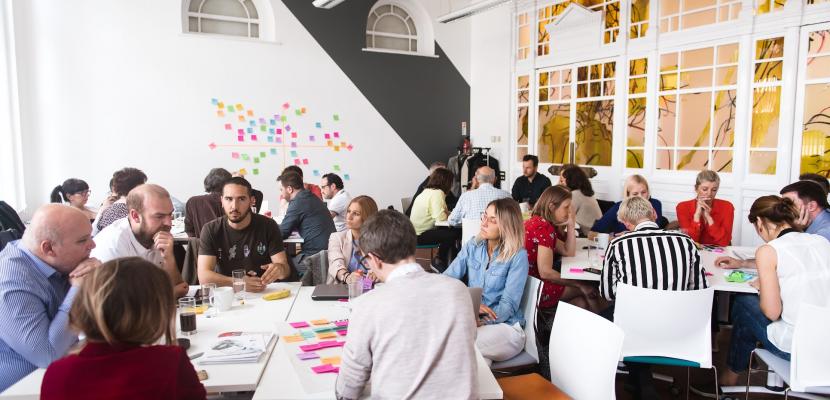Group of people sitting at table and working Group of people sitting at table and working