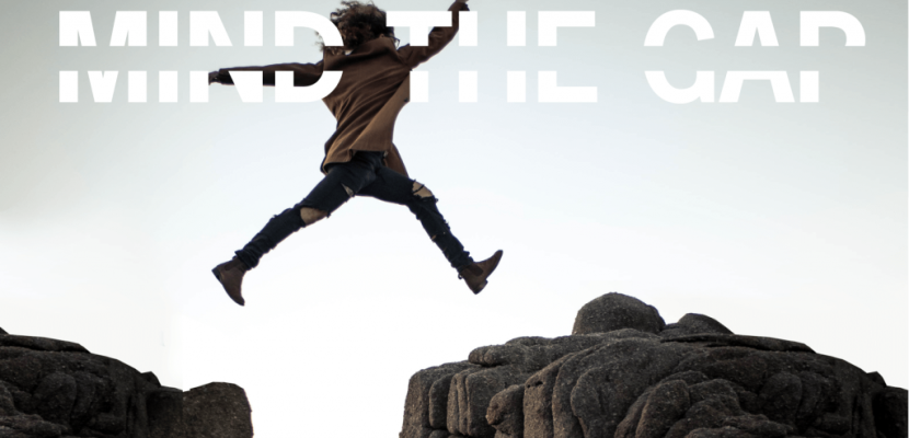 Mind the Gap A person jumping over a gap between two big rocks.