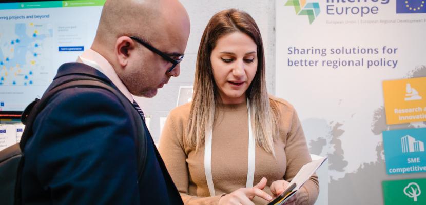 Staff member helps an event attendee with their questions.