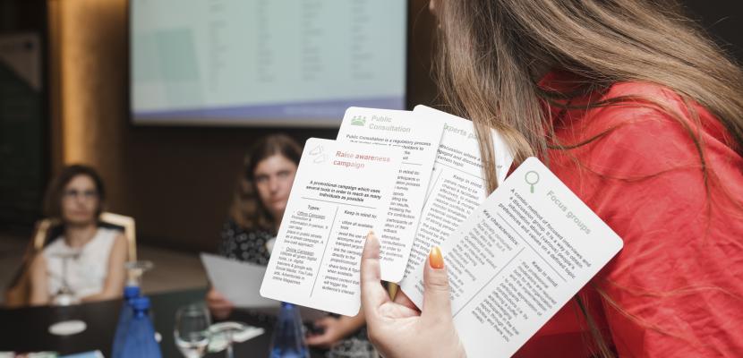 Woman holding up cards Woman holding up cards