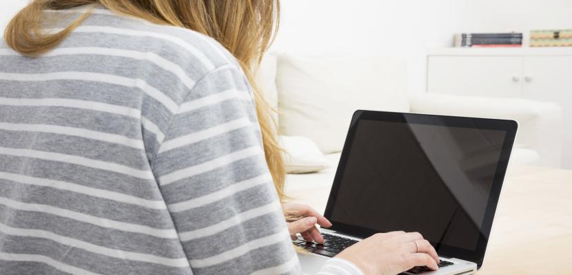 Women using a laptop A close up women using laptop at home