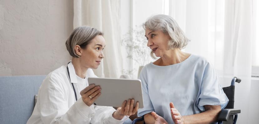 Telemedicine in nursing homes A doctor with a older patient using a connected tablet