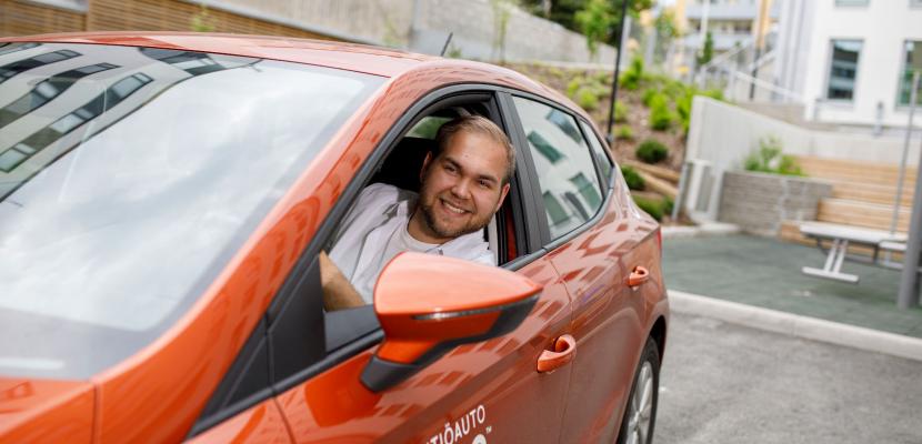 Shared cars for students in Jyväskylä, Finland A man sitting in a shared car and looking out the window.