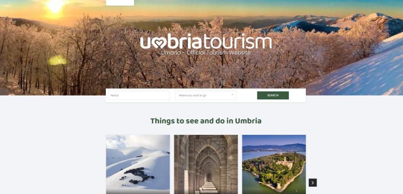 A screenshot of the Umbria Tourism home page showing a snowy scene