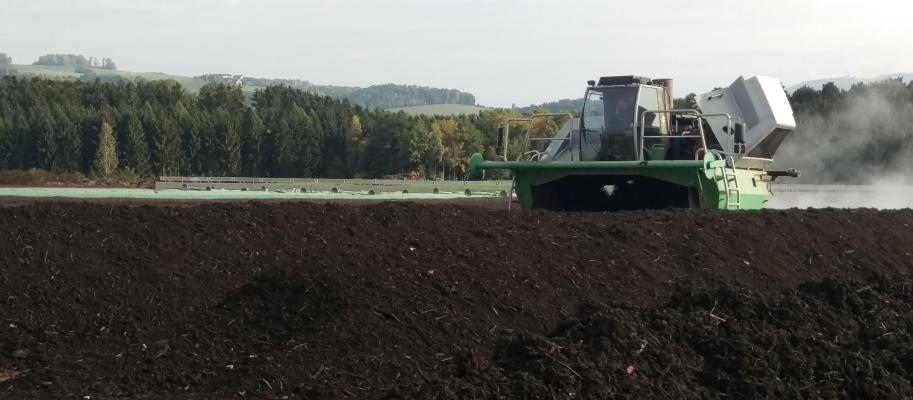 Machines turning over agricultural compost piles 