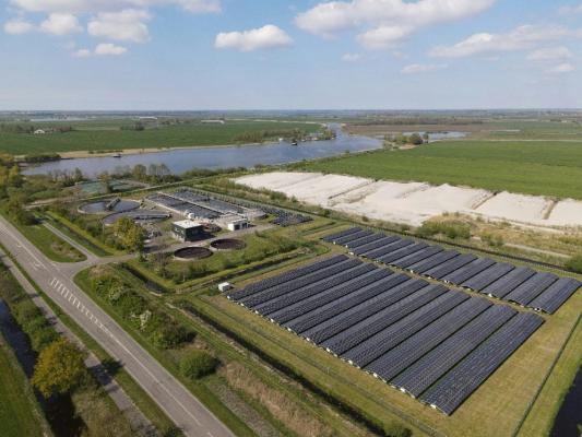 Rows of solar panels in a vast field
