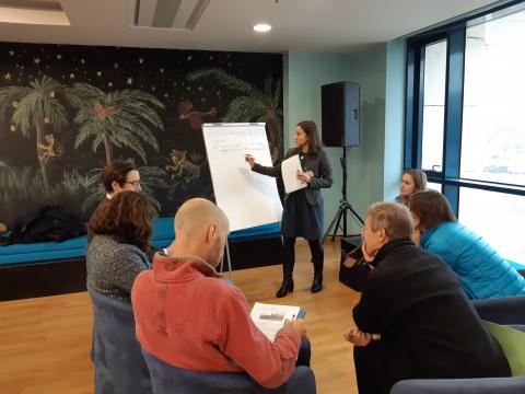 Person writing on whiteboard during event