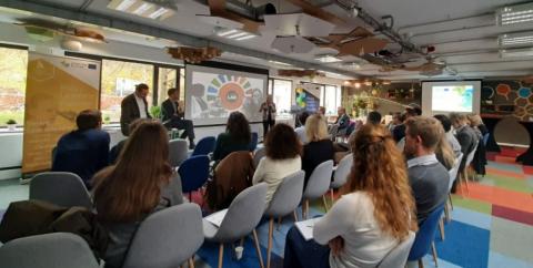 Group of people sitting and listening to a presentation