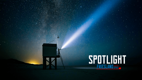 Observation point on a beach with a flashlight pointing at the dark sky 