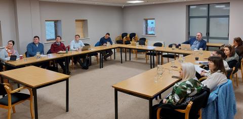 People sitting in a meeting room watching a presentation