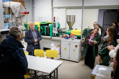 Touring research and testing laboratories at University of Sopron. A group are shown a testing lab for wood products.