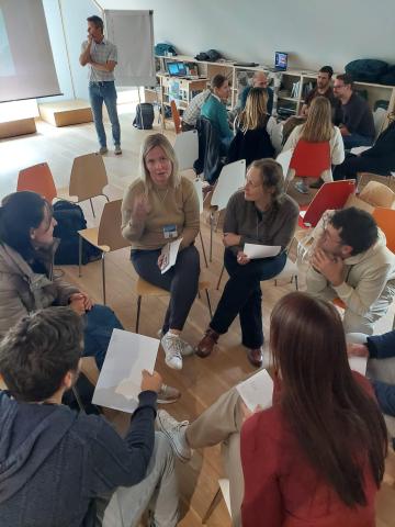 Stakeholders workshop I see many peole sat on chairs