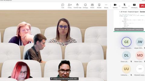 Project partners attend an online meeting on expense reporting, utilizing a virtual auditorium setting to enhance interaction and focus on financial report presentations. Screenshot of an online meeting using a virtual auditorium background, with participants' images placed in theater-style seats. The participants appear engaged in the project discussion, with financial report slides visible on the right side.