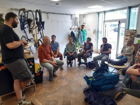 Partners listen to how the Atelier Syklett works Atelier Syklett, the Bicycle Repair Shop