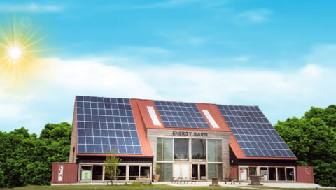 Barn in a sunny green environment with PV elements on the roof