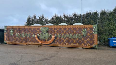 Container painted to look like suitcase Container painted to look like suitcase