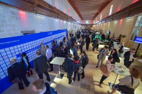 Crowd of people network at 'Europe, let's cooperate' 2017 Crowd of people in a hall way networking at an event.