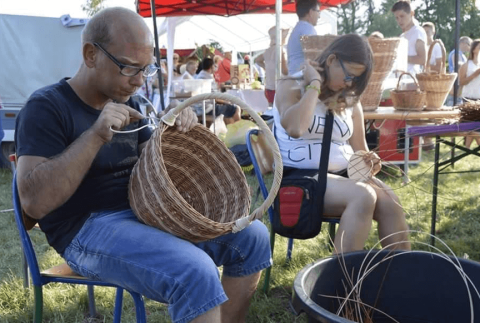Members of the cooperative work together to create wicker products.