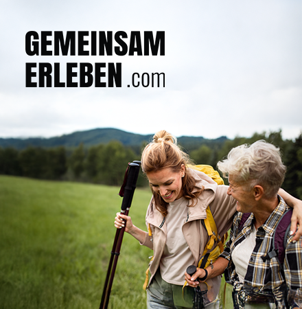 An adult woman and an elderly woman in an outdoor space holding walking poles.  