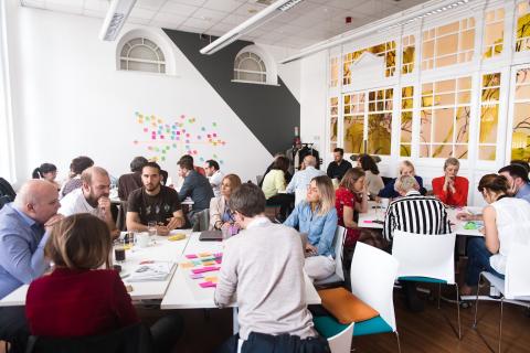 Group of people sitting at table and working