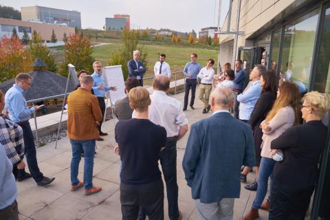 Group of people standing on terrace discussing