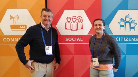 HUMAN partners ERNACT partners in front of red social pull up