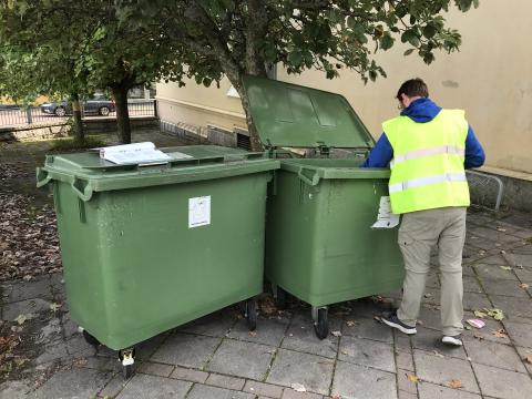 One of the environmental educators goes through the waste at one of our municipal departments