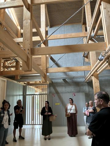 Wood building, France. Poeple inside a modern building built with wooden logs.