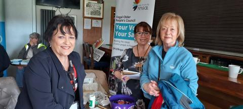 Information Event for older people in Fingal Three woman smiling into the camera at an information event