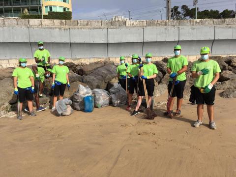 Group of young people after cleaning a beach Group of young people after cleaning a beach