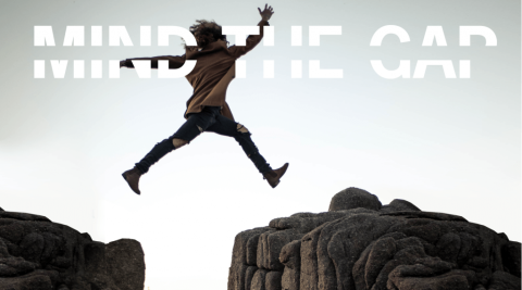 Mind the Gap A person jumping over a gap between two big rocks.