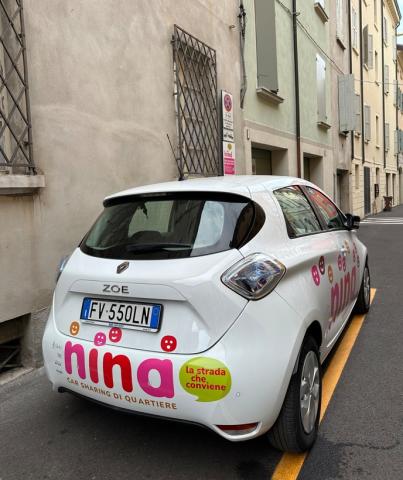 NINA Car sharing NINA car sharing vehicle, parked in a dedicated parking spot in a street of the city of Reggio Emilia.