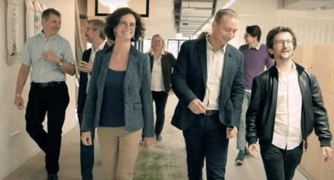 People walking through hallway People walking through hallway