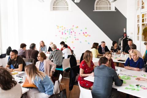 People working in groups on post-its People working in groups on post-its