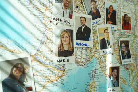 Photos of people pinned of a map