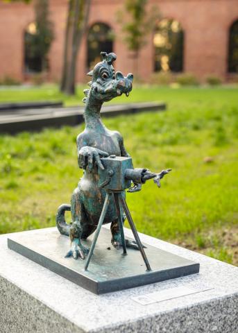 Dragon photographer figurine ('Smok Fotograf' in Polish) placed on ul. Rakowicka, Krakow Figurine of a dragon photographer