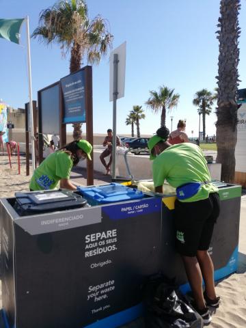 Maintenance of recycling bins by young people on the beach Maintenance of recycling bins by young people on the beach