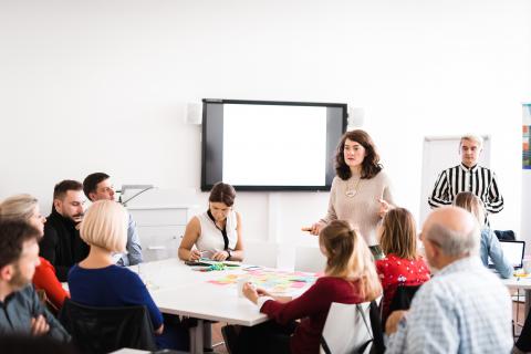 Two people holding a presentation in front of a crowd