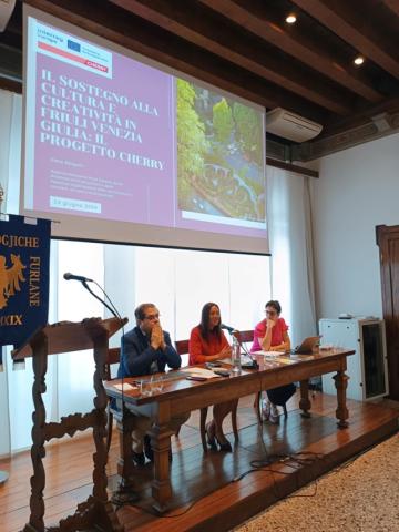 3 people at presentation table indoors