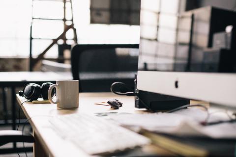 Desk with a computer and a mug Desk with a computer and a mug