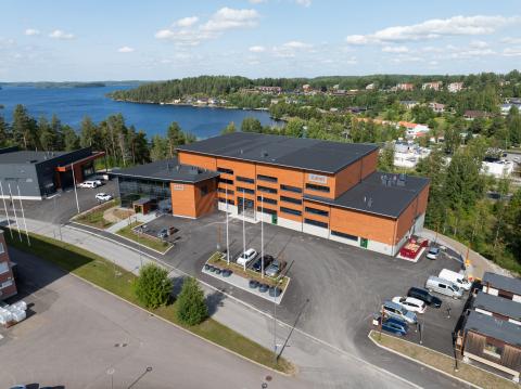 new brown laboratory building with Lake Saimaa in the background