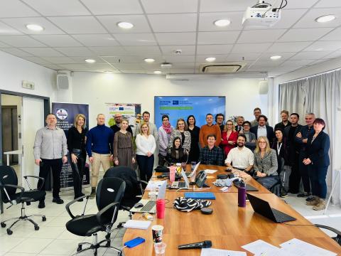 Project partners pose for a group photo in the classroom